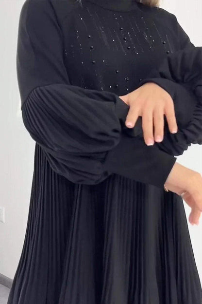 LEYNA - GEPLOOIDE JURK MET FLATTEREND DESIGN